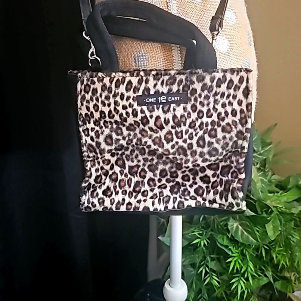 Leopard print purse with 3 compartments.